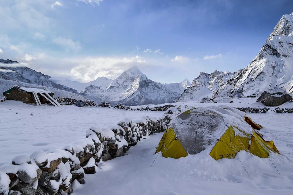 Snowy mountain valley with accent tents